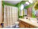 Bright bathroom with colorful shower curtain, window, and wood vanity at 2213 Emery St # C, Longmont, CO 80501