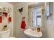 Cozy half-bathroom featuring a pedestal sink and decorative wall art at 2213 Emery St # C, Longmont, CO 80501