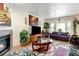 Cozy living room with a fireplace, television, plants, and sofas, perfect for relaxation and entertainment at 2213 Emery St # C, Longmont, CO 80501