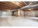 Unfinished basement with concrete floor and exposed wood ceiling at 9928 Candlewood Ct, Highlands Ranch, CO 80126