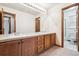 The bathroom features a double vanity and wooden cabinets at 9928 Candlewood Ct, Highlands Ranch, CO 80126