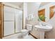 Functional bathroom featuring a pedestal sink and a glass-enclosed shower, providing essential amenities at 9928 Candlewood Ct, Highlands Ranch, CO 80126