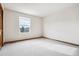 This spacious bedroom features neutral carpeting and a bright window at 9928 Candlewood Ct, Highlands Ranch, CO 80126