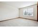 This spacious bedroom features neutral carpeting and a bright window at 9928 Candlewood Ct, Highlands Ranch, CO 80126