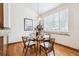 Cozy dining area with hardwood floors, a modern chandelier, and a large window with natural light at 9928 Candlewood Ct, Highlands Ranch, CO 80126