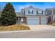 Charming two-story home with a three car garage, manicured lawn, and inviting curb appeal at 9928 Candlewood Ct, Highlands Ranch, CO 80126