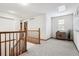 Bright, carpeted upstairs hallway with wood railing, connects the home's living spaces elegantly at 9928 Candlewood Ct, Highlands Ranch, CO 80126