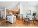 Bright eat-in kitchen features wood cabinets, stainless appliances, hardwood floors and a vaulted ceiling at 9928 Candlewood Ct, Highlands Ranch, CO 80126