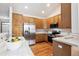 Spacious kitchen with wood cabinets, stainless steel appliances, and a tiled backsplash at 9928 Candlewood Ct, Highlands Ranch, CO 80126