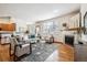 Inviting living room with hardwood floors, fireplace, and large windows providing plenty of natural light at 9928 Candlewood Ct, Highlands Ranch, CO 80126