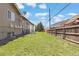 Backyard featuring a large grassy area and a wooden fence surrounding the perimeter at 8367 S Reed St # A3, Littleton, CO 80128
