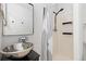 Stylish bathroom with a modern sink, mirror, and shower featuring a black shower head at 8367 S Reed St # A3, Littleton, CO 80128