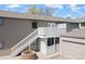 Apartment building featuring stairs leading to a private deck and access to the garage at 8367 S Reed St # A3, Littleton, CO 80128