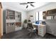 Contemporary home office featuring hardwood floors, a stylish desk, and ample storage at 8367 S Reed St # A3, Littleton, CO 80128