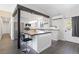Modern kitchen with stainless steel appliances, granite counters, and breakfast bar at 8367 S Reed St # A3, Littleton, CO 80128