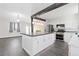 Bright kitchen featuring a center island, stainless steel appliances and hardwood floors at 8367 S Reed St # A3, Littleton, CO 80128