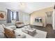 Bright living room features shiplap accent wall, modern furniture, and access to the outside through double doors at 8367 S Reed St # A3, Littleton, CO 80128