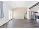 Open living space features shiplap accent wall and leads to a modern kitchen at 8367 S Reed St # A3, Littleton, CO 80128