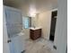 Bathroom featuring stacked washer and dryer and a vanity at 9995 E Harvard Ave # 261, Denver, CO 80231
