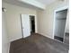 Cozy bedroom with neutral walls, plush carpeting, closet and white door at 9995 E Harvard Ave # 261, Denver, CO 80231