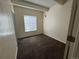Bedroom with light walls, window, plush carpet and sliding door closet at 9995 E Harvard Ave # 261, Denver, CO 80231