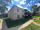 Two-story condo building with wooden balconies, landscaping and pathway at 9995 E Harvard Ave # 261, Denver, CO 80231