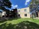 Tan apartment building exterior with green lawn and mature trees on a sunny day at 9995 E Harvard Ave # 261, Denver, CO 80231