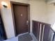 Brown front door with peephole and a combination lock at 9995 E Harvard Ave # 261, Denver, CO 80231