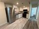 Kitchen with stainless appliances, granite counters and white cabinets at 9995 E Harvard Ave # 261, Denver, CO 80231