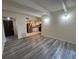 Open living room with plank floors, open to kitchen, and bright lighting at 9995 E Harvard Ave # 261, Denver, CO 80231