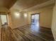 Living room with laminate flooring and large sliding glass doors to a patio at 9995 E Harvard Ave # 261, Denver, CO 80231