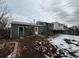 View of back exterior with a small backyard partially covered with snow at 1170 W 135Th Dr, Denver, CO 80234