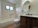 Well-lit bathroom features vanity with storage, toilet, and a shower-tub combo at 1170 W 135Th Dr, Denver, CO 80234