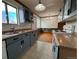 Bright kitchen with blue cabinets, an electric stove, and a stainless steel sink at 1170 W 135Th Dr, Denver, CO 80234