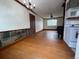 A sunlit living room featuring hardwood floors and decorative wall tiles at 1170 W 135Th Dr, Denver, CO 80234