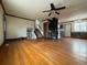 Large living room featuring hardwood floors, a wood stove, and an adjacent staircase at 1170 W 135Th Dr, Denver, CO 80234