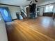 Spacious living room showcasing hardwood floors, a wood-burning stove, and an entry door at 1170 W 135Th Dr, Denver, CO 80234