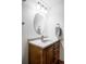 Traditional bathroom vanity with a round mirror and a towel rack for convenience at 9257 Shadowglen Ct, Highlands Ranch, CO 80126