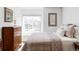 Inviting bedroom with a large window, chest of drawers, and comfortable bedding at 9257 Shadowglen Ct, Highlands Ranch, CO 80126