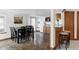 Open-concept dining room with modern table and chairs, flows into the kitchen area at 9257 Shadowglen Ct, Highlands Ranch, CO 80126