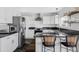 Modern kitchen with stainless steel appliances, granite countertops, and stylish bar seating at 9257 Shadowglen Ct, Highlands Ranch, CO 80126