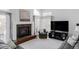 Comfortable living room featuring a fireplace, sofa, armchair, and a large TV at 9257 Shadowglen Ct, Highlands Ranch, CO 80126