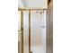 Bathroom features shower with gold trim and tiled walls and flooring at 9257 Shadowglen Ct, Highlands Ranch, CO 80126