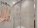Tiled shower with glass door and a shower head. Towels hang to the side at 1234 Riddlewood Ln, Highlands Ranch, CO 80129