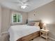 Bedroom featuring a queen-sized bed, ceiling fan, and large window offering natural light at 1234 Riddlewood Ln, Highlands Ranch, CO 80129