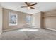 Bright bedroom with neutral walls, carpet, and large windows at 1912 S Truckee St, Aurora, CO 80013