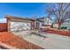 Brick and light-colored siding home with a two-car garage and mature tree at 1912 S Truckee St, Aurora, CO 80013