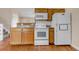 View of kitchen, white appliances, wood cabinets at 1912 S Truckee St, Aurora, CO 80013