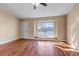 Bright living room with hardwood floors, large window, and ceiling fan at 1912 S Truckee St, Aurora, CO 80013