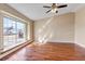 Living room featuring hardwood floors, a large window, and ceiling fan at 1912 S Truckee St, Aurora, CO 80013